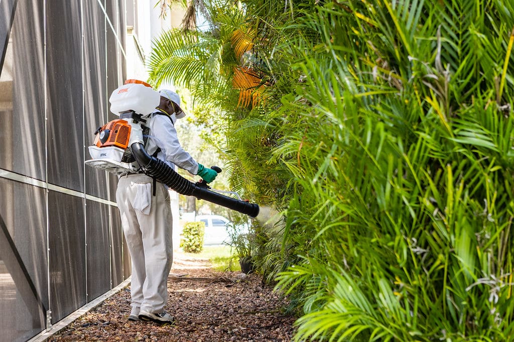 technician spraying for mosquitoes